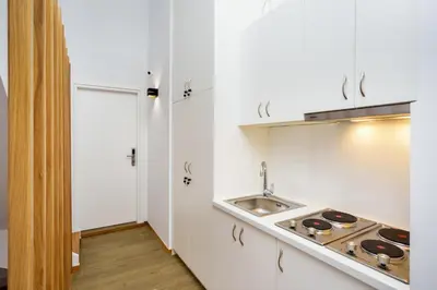 a white kitchen with a sink and a stove at Elia Portou Luxury Residence in Chania Town