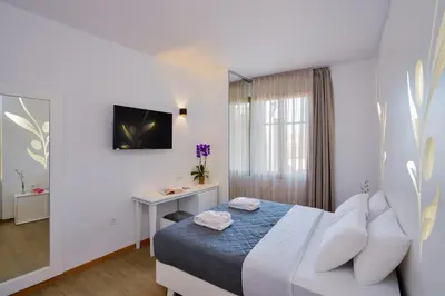 a hotel room with a bed and a desk at Elia Portou Luxury Residence in Chania Town
