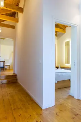a room with a bed and a room with a hallway at Villa Skyphos in Ammoudari