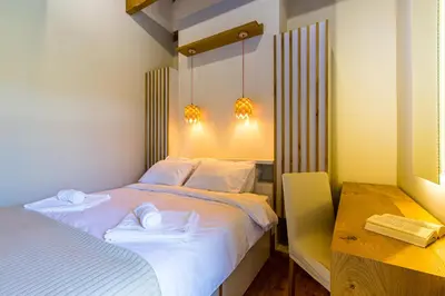 a bedroom with a bed with two towels on it at Villa Skyphos in Ammoudari