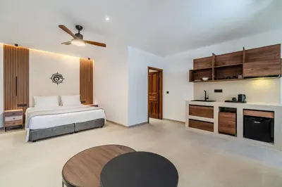 a bedroom with a bed and a table in a room at VENTUS Studios in Khóra Sfakíon