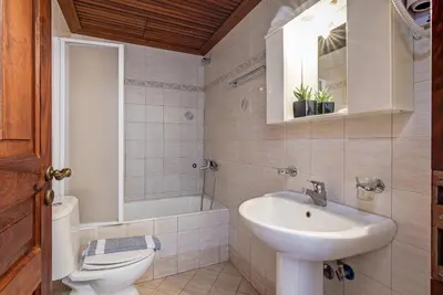 a bathroom with a sink and a toilet and a sink at VENTUS Studios in Khóra Sfakíon