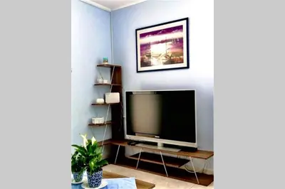a living room with a flat screen tv on a shelf at Nikoleta Apartment in Chania Town