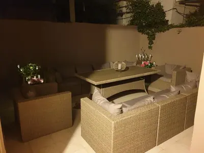 a table and chairs in a room with a couch at Nikoleta Apartment in Chania Town