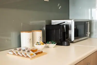 a kitchen counter with a coffee maker and a microwave at Calme luxury residence in Chania Town