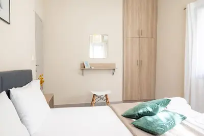 a bedroom with a bed with two pillows on it at Calme luxury residence in Chania Town