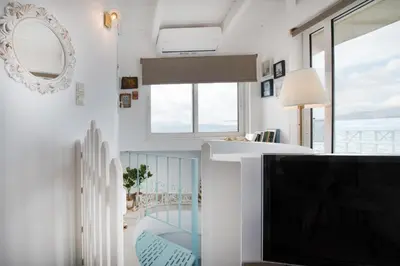 a living room with a tv and a balcony at Dream House Efi in Ravdhoúkha