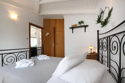 a bedroom with a bed with two towels on it at Dream House Efi in Ravdhoúkha