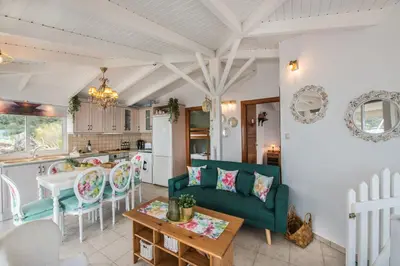 a living room with a couch and a table at Dream House Efi in Ravdhoúkha