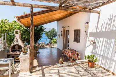 a patio with a wooden pergola and a table at House with Private Place To Swim, Solitary, View in Ravdhoúkha