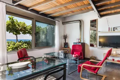 a living room with a glass table and red chairs at House with Private Place To Swim, Solitary, View in Ravdhoúkha