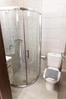 a bathroom with a shower and a toilet at Irene Suite Chania in Kato Daratso