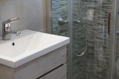 a bathroom with a sink and a shower at Nicky Apartments Chania in Chania Town