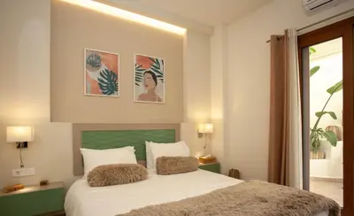 a bedroom with a bed with two pillows on it at Blue Jasmine Apartments in Chania Town