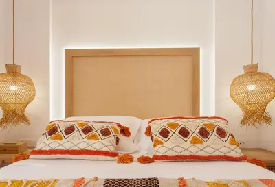 a bedroom with a bed with two pillows and a window at Blue Jasmine Apartments in Chania Town