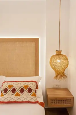 a bedroom with a bed and a chandelier at Blue Jasmine Apartments in Chania Town