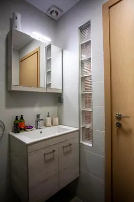 a bathroom with a sink and a mirror at Blue Jasmine Apartments in Chania Town