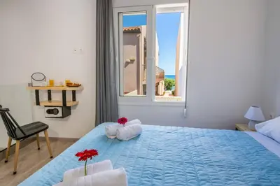 a bedroom with a large blue bed with a window at 