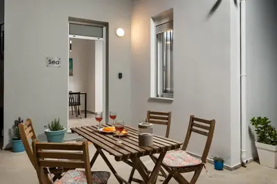 a wooden table and chairs with wine glasses on it at 