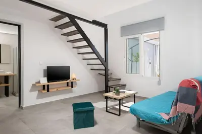 a living room with a staircase and a couch at 