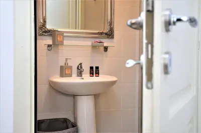 a bathroom with a sink and a mirror at Chania 1548 Old Town Apartments in Chania Town