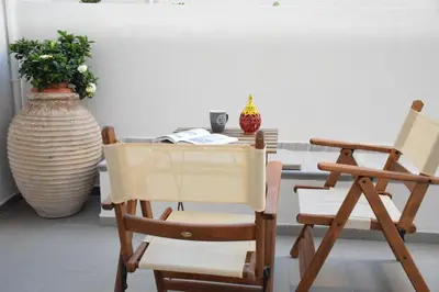 a dining room with two chairs and a table at Chania 1548 Old Town Apartments in Chania Town