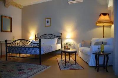 a bedroom with two beds and a couch at Chania 1548 Old Town Apartments in Chania Town