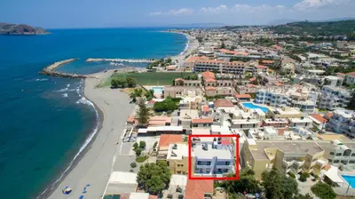 an aerial view of a town next to the ocean at Linda Apartments Platanias in Plataniás