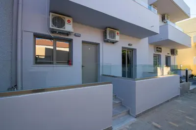 a building with a glass counter in front of it at Linda Apartments Platanias in Plataniás