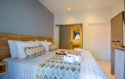 a bedroom with a bed with two stuffed animals on it at Linda Apartments Platanias in Plataniás