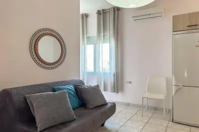 a living room with a couch and a mirror at Alisahni Home 2 in Daratso