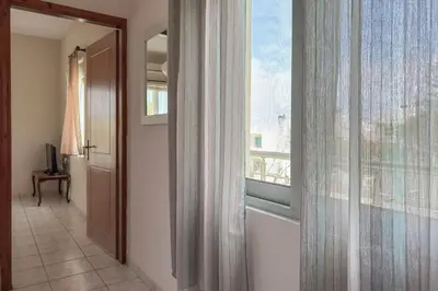 a hallway with a large window and a door at Alisahni Home 2 in Daratso