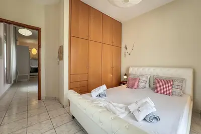 a bedroom with a white bed with pillows on it at Alisahni Home 2 in Daratso