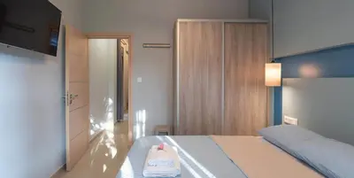 a bedroom with a bed with a towel on it at On the sand 1 in Palaiochóra