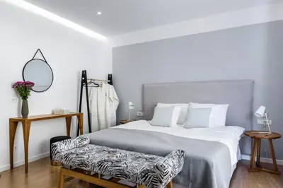 a bedroom with a large bed with a zebra print chair at Balance Hotel in Chania Town
