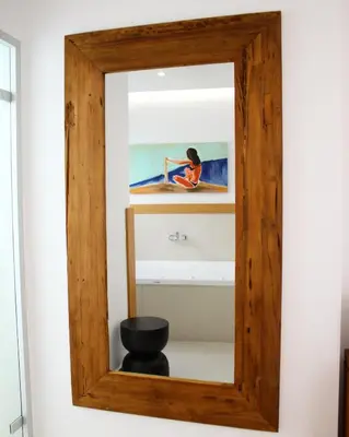 a mirror with a woman sitting on a surfboard at Balance Hotel in Chania Town