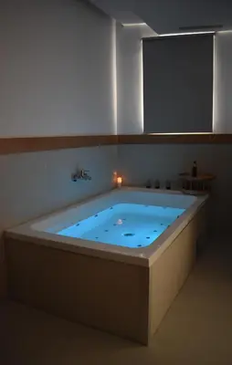 a jacuzzi tub in a room with a mirror at Balance Hotel in Chania Town