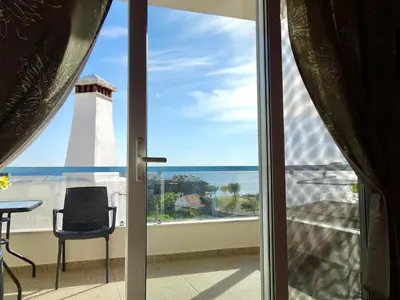 a view of a lighthouse from a room with a window at Faros apartment in Sfakiá