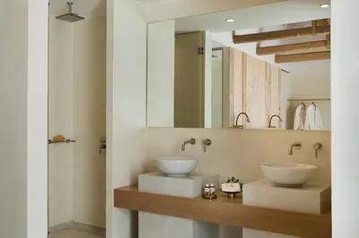 a bathroom with two sinks and a mirror at Mirabile Luxury Suites in Chania Town