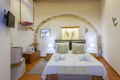 a bedroom with a bed and a tv in a room at Charming Flatlet in the Old Town in Chania Town