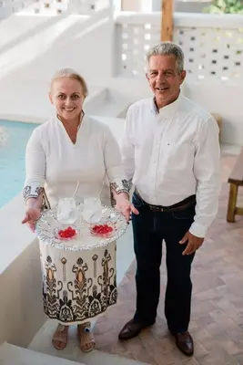 a man and a woman holding a table with a cake at Cretan Soul in Plataniás