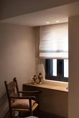 a room with a window with a chair and a window shade at Cretan Soul in Plataniás