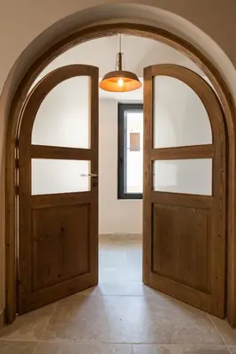 an archway with a wooden door in a room at Cretan Soul in Plataniás