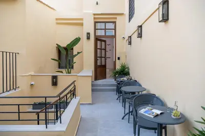 a corridor of a restaurant with tables and chairs at Camere Maritima in Chania Town