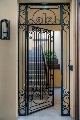 a iron gate with a staircase in a hallway at Camere Maritima in Chania Town