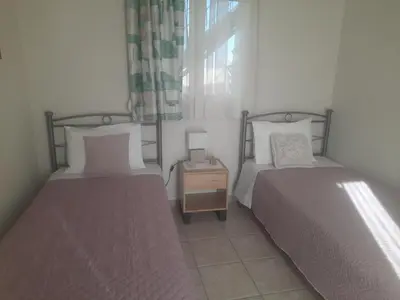 a bedroom with two beds and a night stand at George's House between Falasarna and Balos in Kissamos