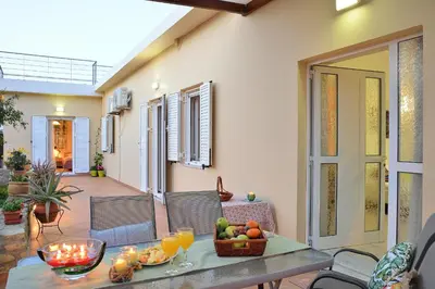 a table with a basket of fruit on a patio at George's House between Falasarna and Balos in Kissamos