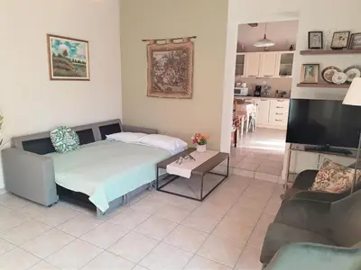 a bedroom with a bed and a living room at George's House between Falasarna and Balos in Kissamos