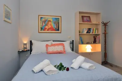 a bedroom with a bed with two towels on it at George's House between Falasarna and Balos in Kissamos