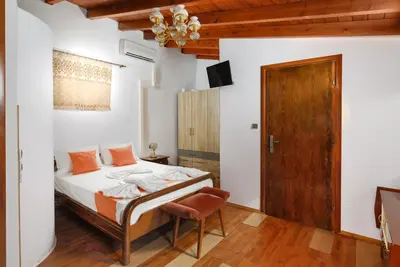 a bedroom with a bed and a wooden door at Matzi House in Chania Town